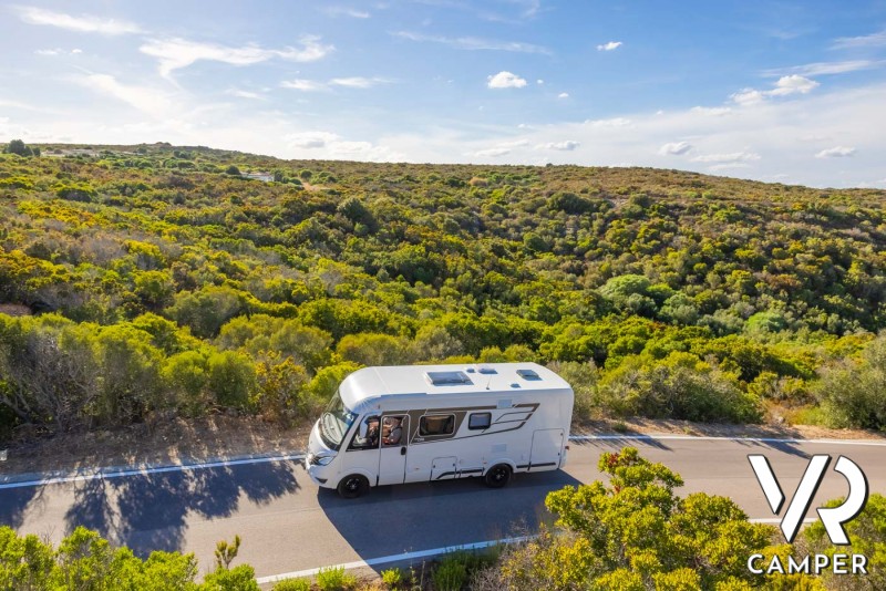 Camper motorhome Hymer su strada tra i campi verdi
